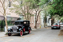 vintage automobile in front of a historic home 