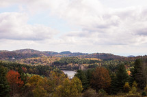 lake surrounded by trees in a forest in fall 