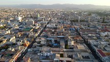 Aerial shot drone flies toward south of Arequipa at dusk