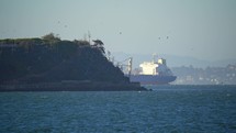 Container Ship Passing Behind Alcatraz Island in San Francisco Bay, California	