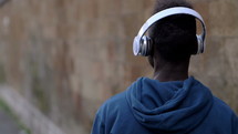 man walking listening to headphones 