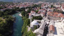 Aerial circling Koski Mehmed Pasha Mosque Ottoman architecture in Mostar city Bosnia and Herzegovina
