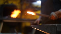 Blacksmith Forging Sword with Sparks in a Workshop