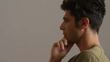Side profile of a man who turns and looks into the camera.