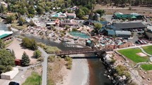 Aerial Fly Up of Hot Springs Resort and River Bridge