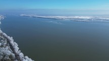 Snow-covered Landscape By The Danube River During Winter In Galati, Romania. aerial pan shot	