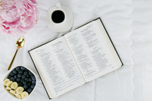 peonies, cup of coffee, bowl of fruit, and open pages of a Bible 