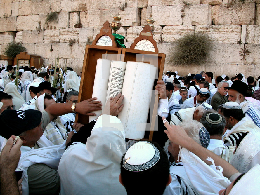 Men touching a Torah Scroll at the Western Wall.