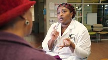 African American woman doctor interacting with patient 