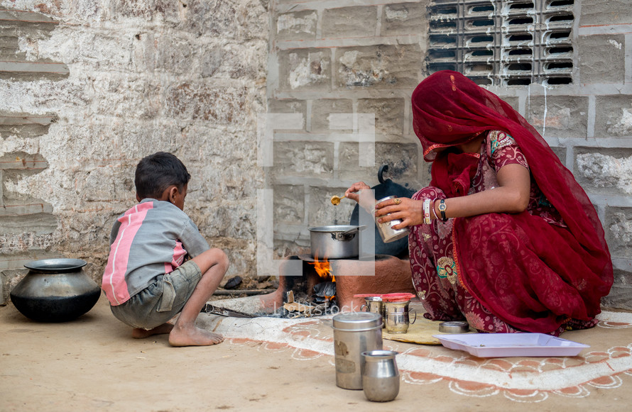 a woman cooking on the streets of India 