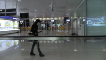 people walking through an airport 