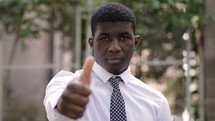 young man giving a thumbs up 