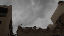 Storm and rain clouds moving over middle eastern city of Old Dubai.