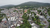 Aerial approaching Markgraf-Ludwig-Gymnasium, a striking cityscape formative yellow school building in Baden-Baden, Germany