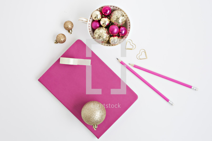 gold and fuchsia ornaments on a white background 