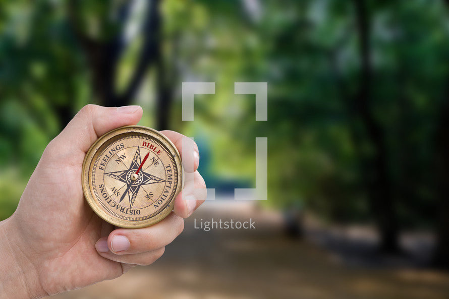 hand holding a Christian compass