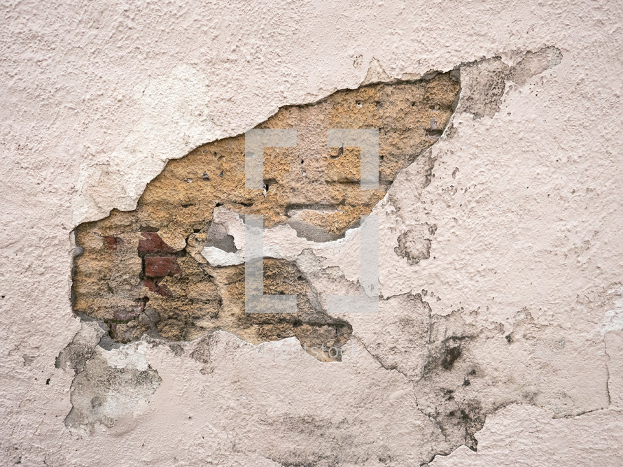 rough wall texture revealing exposed brick, run down