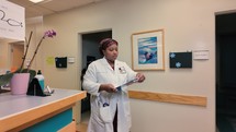 African American woman doctor walking shot 