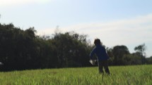 boy child running in a field outdoors 
