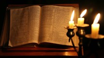 burning candles and an open Bible 