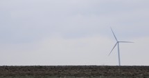 Wind Turbine Generating Renewable Energy At The Wind Farm. wide shot