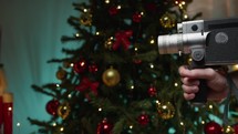 Santa Claus with Super 8 camera moving towards tree