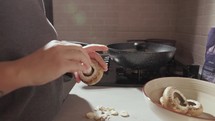 Woman Cutting And Cleaning Mushrooms In The Kitchen - Close Up