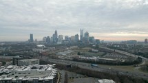 Rising drone shot of downtown Charlotte's skyline on an overcast morning