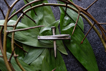 cross of nails, crown of thorns, and palm fronds 