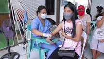 Asian Woman Getting Blood Pressure Taken Covid Screening