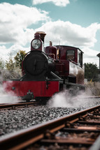 Steam train on a railway track, coal powered steam engine locomotive