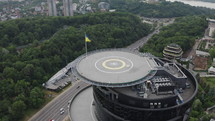 Circular Drone Aerial of Helicopter Helipad on the Roof Top in Kyiv City Ukraine with city background and Ukrainian Flag