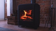 Log burner interior fireplace, warm cosy winter interior fire, wood fire burning, rustic heating