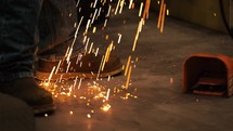 Welders shoes with sparks landing by feet 2