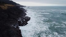 Cinematic Drone shot flying over coastline on an overcast day.