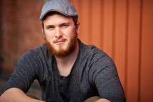 A man wearing a hat that has a red beard