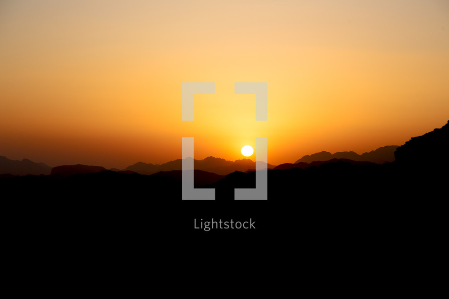 desert sunrise panoramic scene and light over mountains 