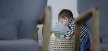 Toddler boy throws up into toy basket