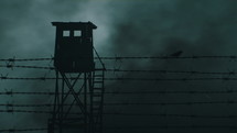 "Barbed wire remains of iron curtain. Sparrow and watchtower."
