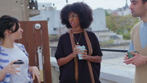 Young Business People Chatting when Having Coffee Break on Balcony
