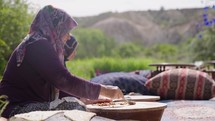 Turkey, Goreme, May 2023: Turkish elderly woman making falafel flat bread. Traditional turkish cuisine
