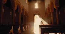 Man praying in the Church with sunlight