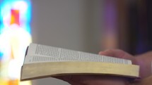 a man opening a Bible in church 