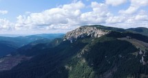 Hasmasul Mare Massif, Piatra Singuratica. Rocky Forested Mountain In Harghita County, Romania. wide aerial