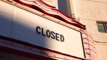 Tight shot of a theatre sign with the word closed on marquis