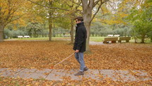 blind man walking in a park 