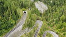 Aerial view of a winding road and tunnel in Bicaz Gorge in Romania.