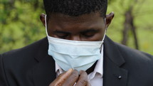 a man in a face mask having trouble breathing 