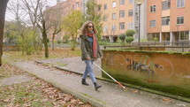blind woman walking in a park 