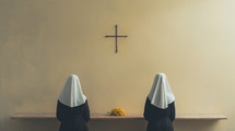 The two nuns in front of a cross